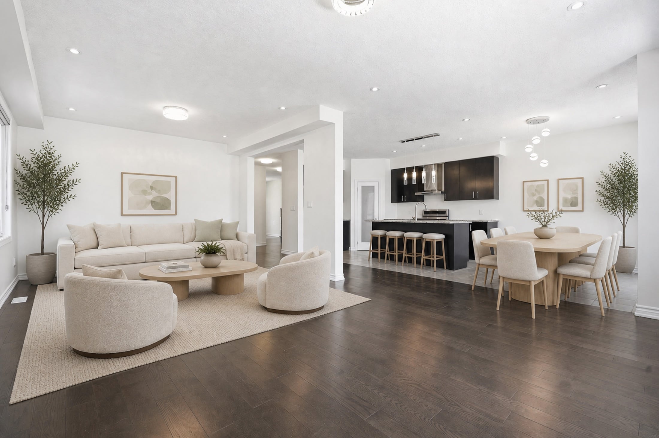 Virtually staged open-concept living, dining and kitchen area
