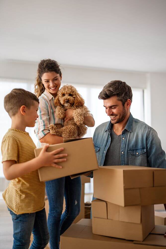 Happy family with cardboard boxes in new house at moving day. Mortgage, family, real estate concept (1) (1)