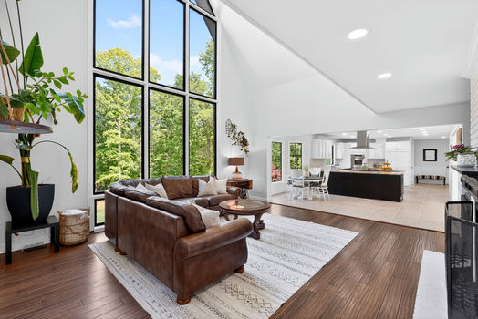 Living room with large picture windows at 106 Riverbank Ct in Moore SC overlooking wooded yard