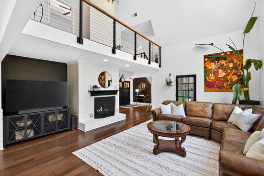 Living room at 106 Riverbank Ct in Moore SC with fireplace, loft overlook, and open layout
