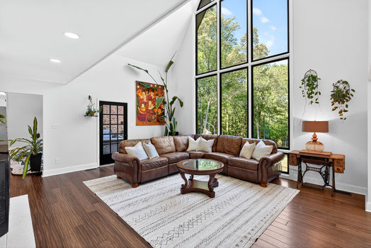 Open living room and kitchen at 106 Riverbank Ct in Moore SC with vaulted ceilings and large windows