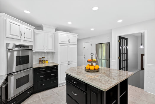Granite island and custom cabinetry in kitchen at 106 Riverbank Ct in Moore SC with stainless appliances