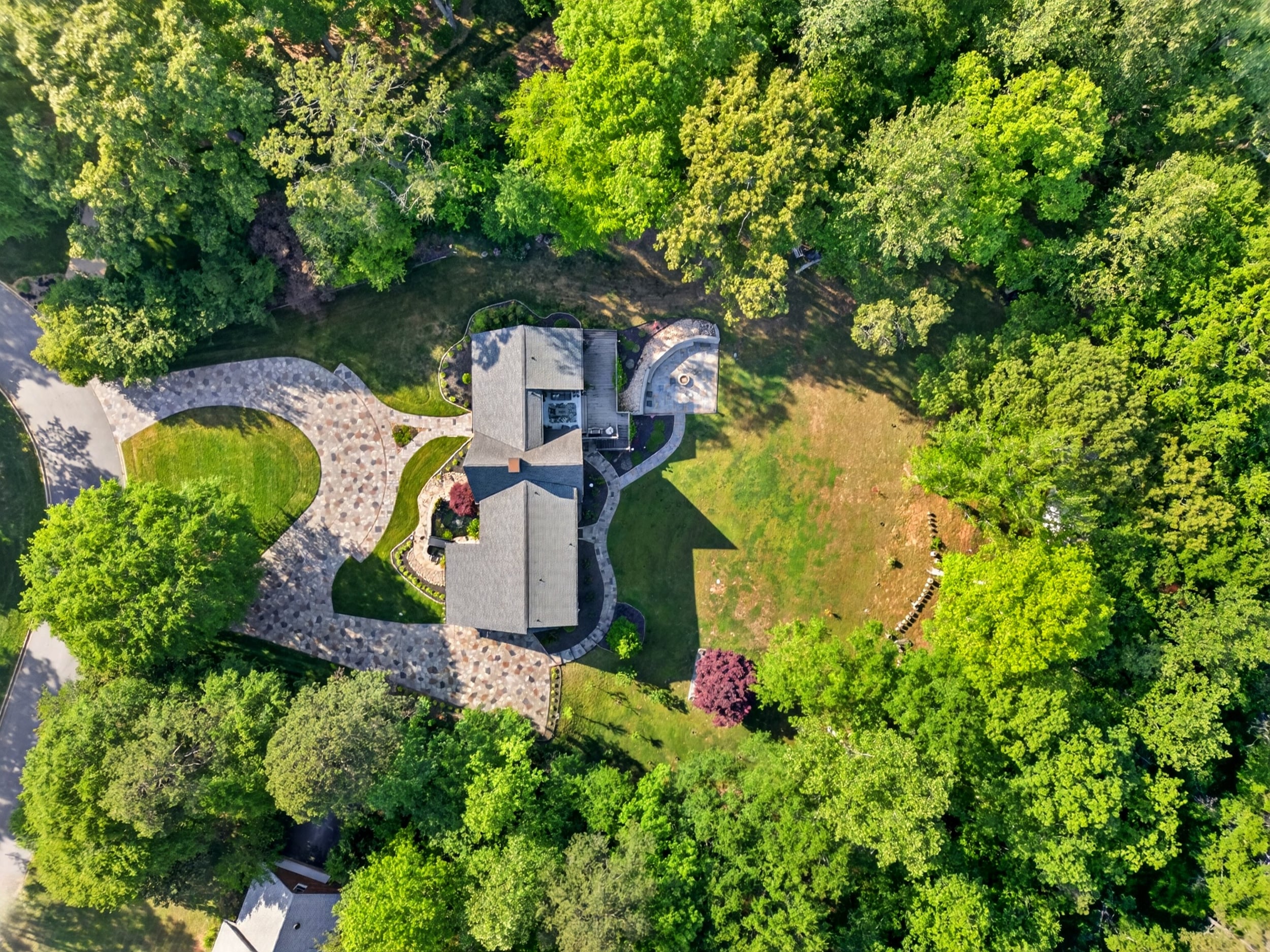 Aerial view of 106 Riverbank Court in Moore SC showing private wooded 1 acre lot, circular driveway, and backyard layout