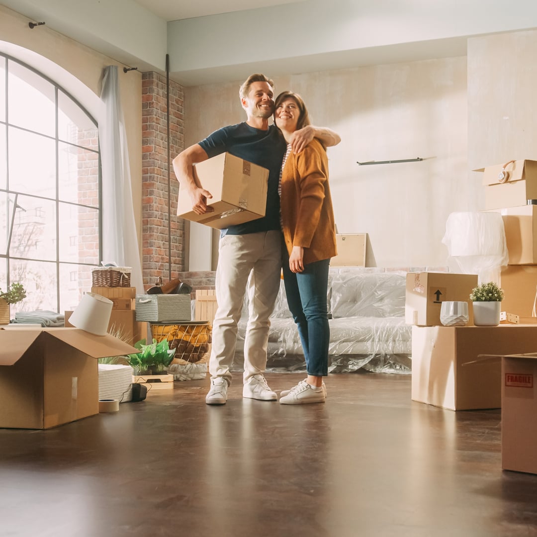 Family-New-Home-Moving-in-Happy-and-Excited-Young-Couple-Enter-Newly-Purchased-Apartment.-Beautiful-Family-Happily-Embracing.-Modern-Home-Ready-for-Decorations.-Mortgage-Loan,-Investment-Concept