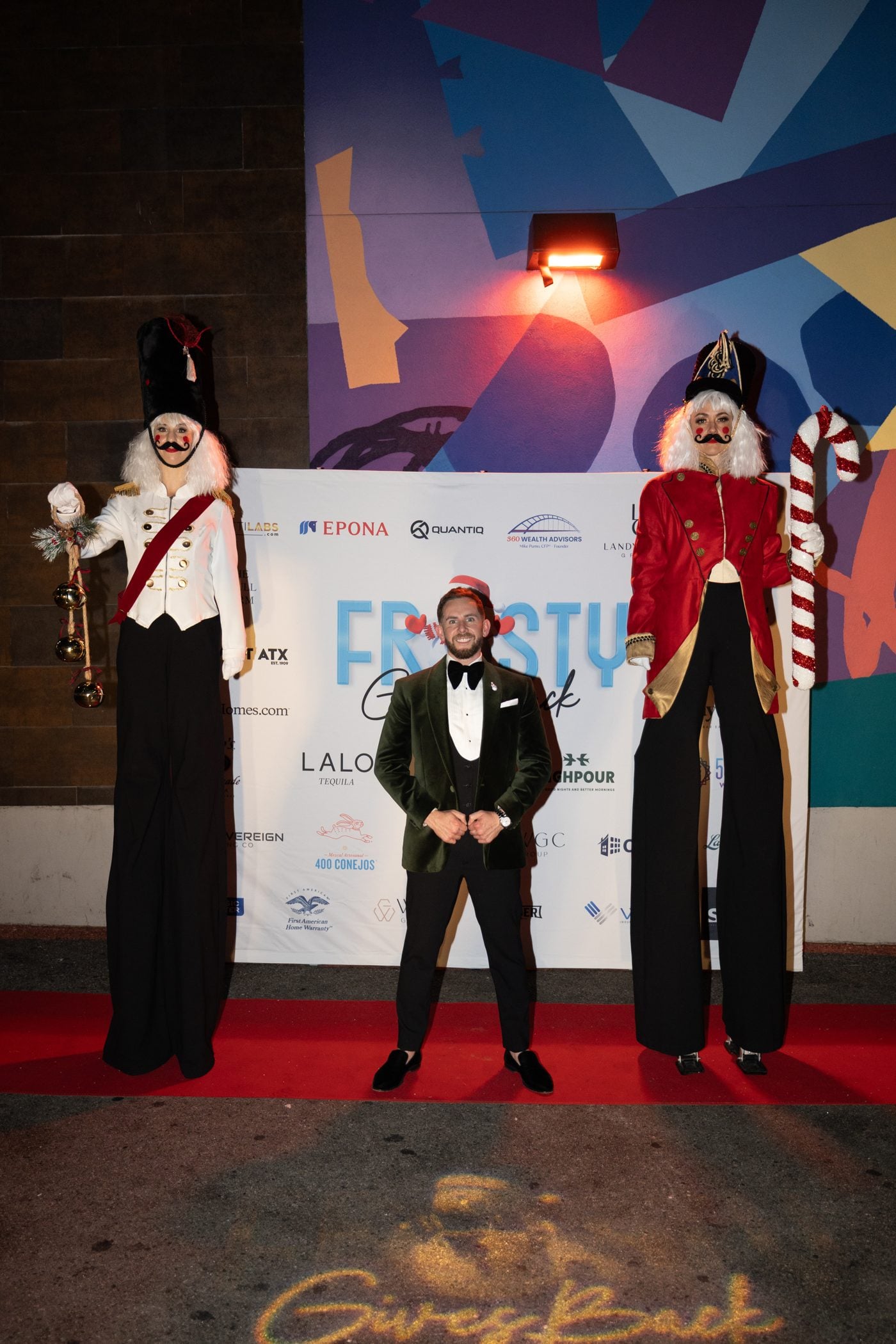Red carpet with nutcracker stilt walkers at the Frosty Gives Back holiday gala in Austin