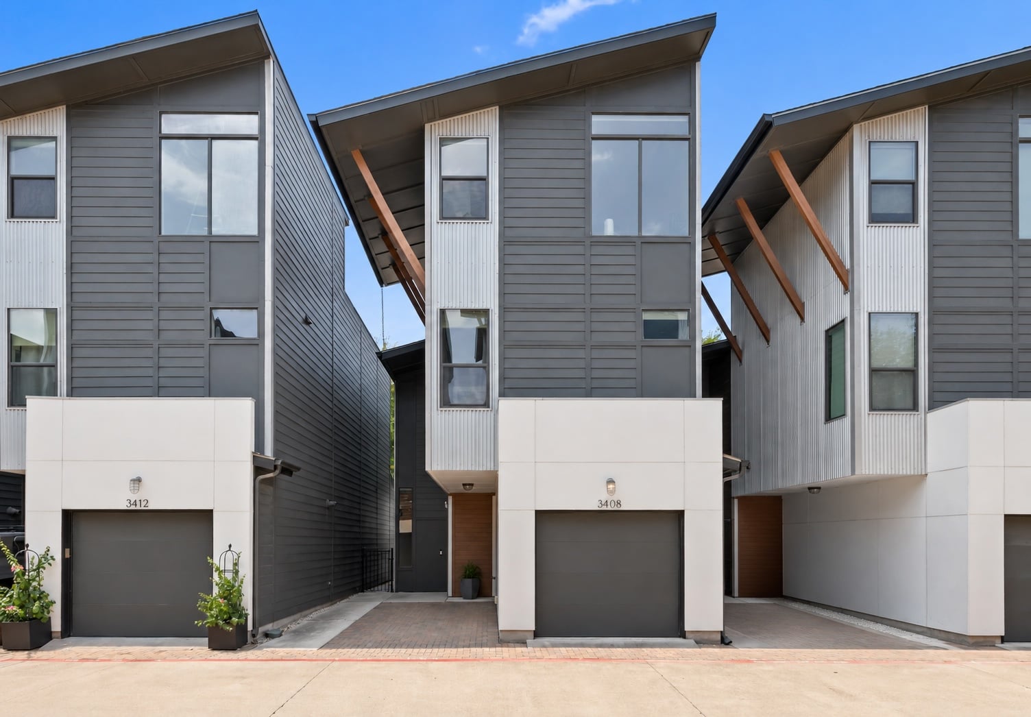 Front exterior of 3408 Charlotte Rose Dr, a modern three-story detached condo with a one-car garage in Austin 78704