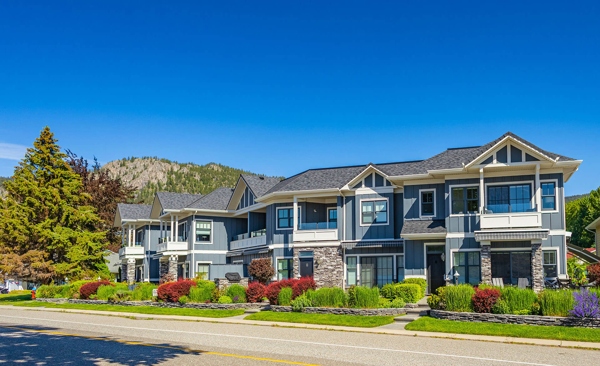 Neighborhood modern houses building in BC, Canada. Canadian modern residential architecture, low-rise-Kelowna BC, Canada. Nobody, street photo