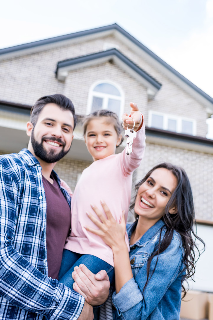 young-family-with-keys-moving-into-new-house
