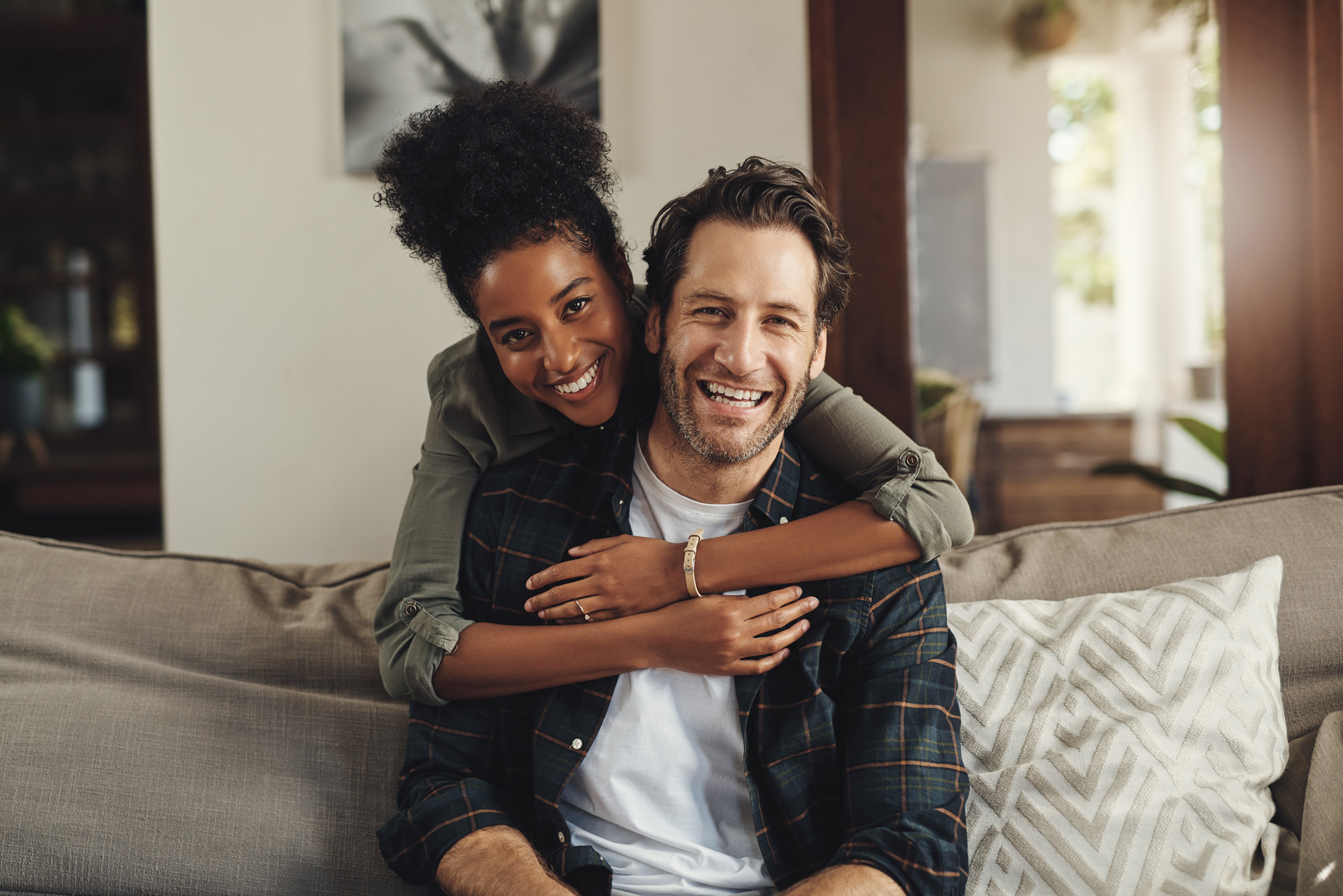 Happy,,Hug,And,Couple,With,Portrait,On,Sofa,For,Weekend