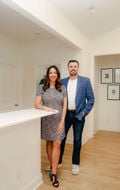 Courtney & Philip, from Britt & Co. Real Estate Professionals, team couple she has a black and white dress a he is in a blue suit with jeans