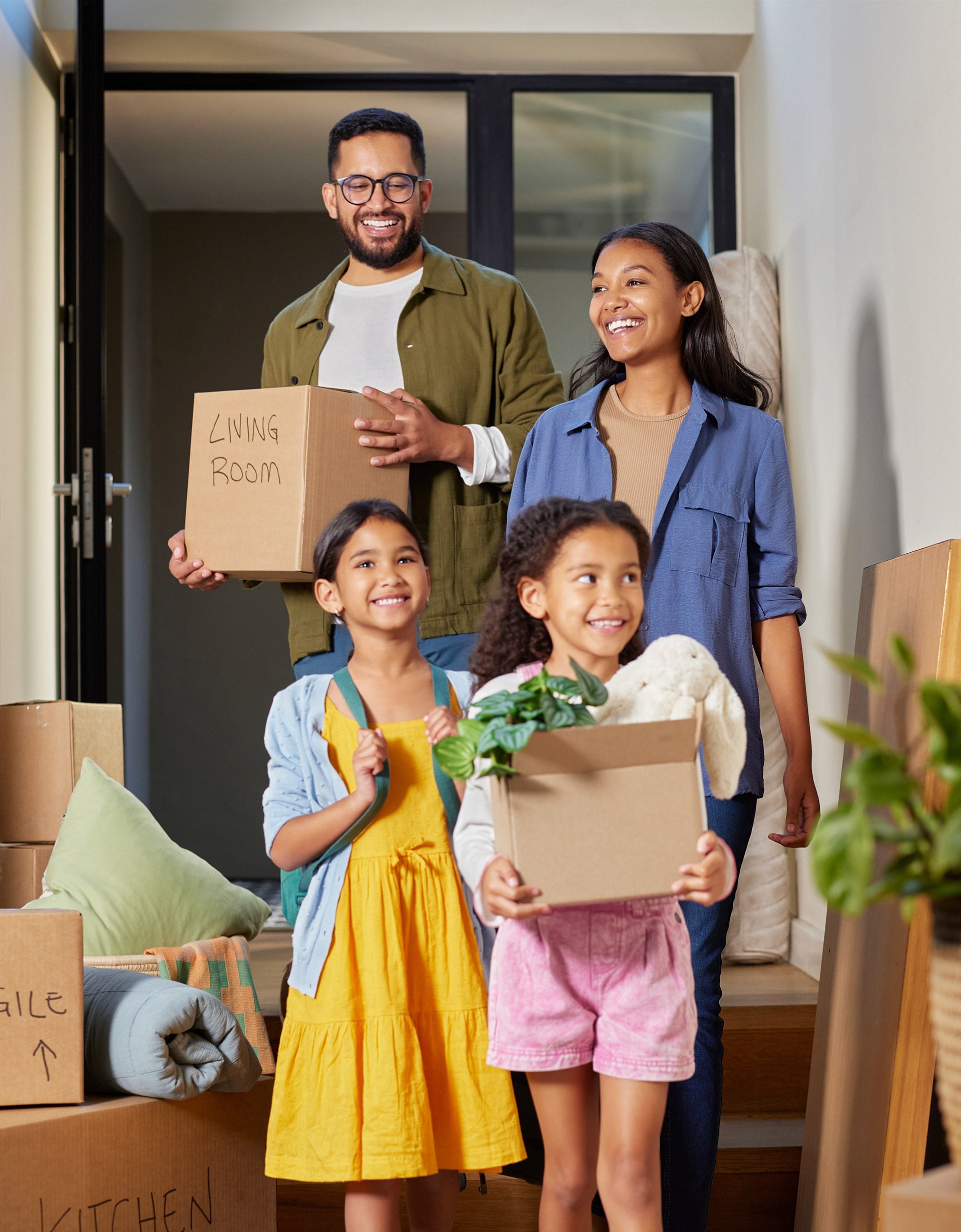 Happy,Mixed,Race,Family,Moving,Into,A,New,Home,Together.
