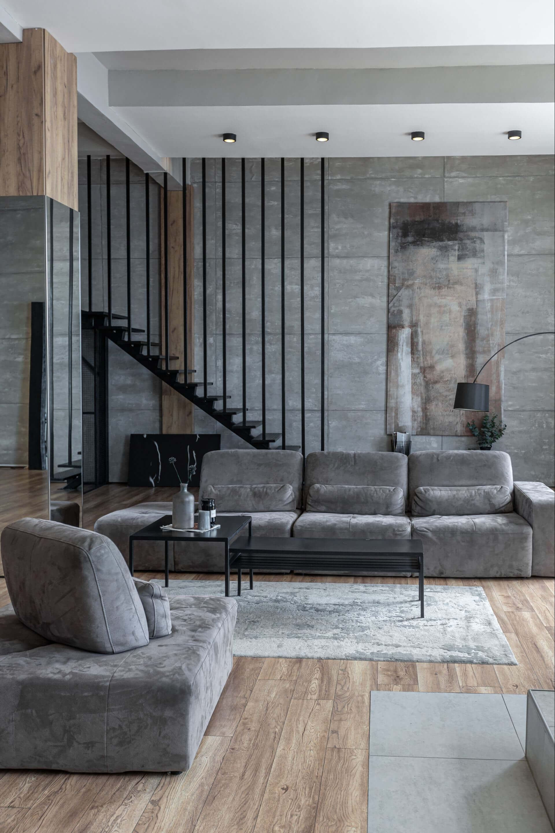 stylish minimalistic restrained modern interior of a two-storey apartment without people in the daytime in loft style in gray tones.