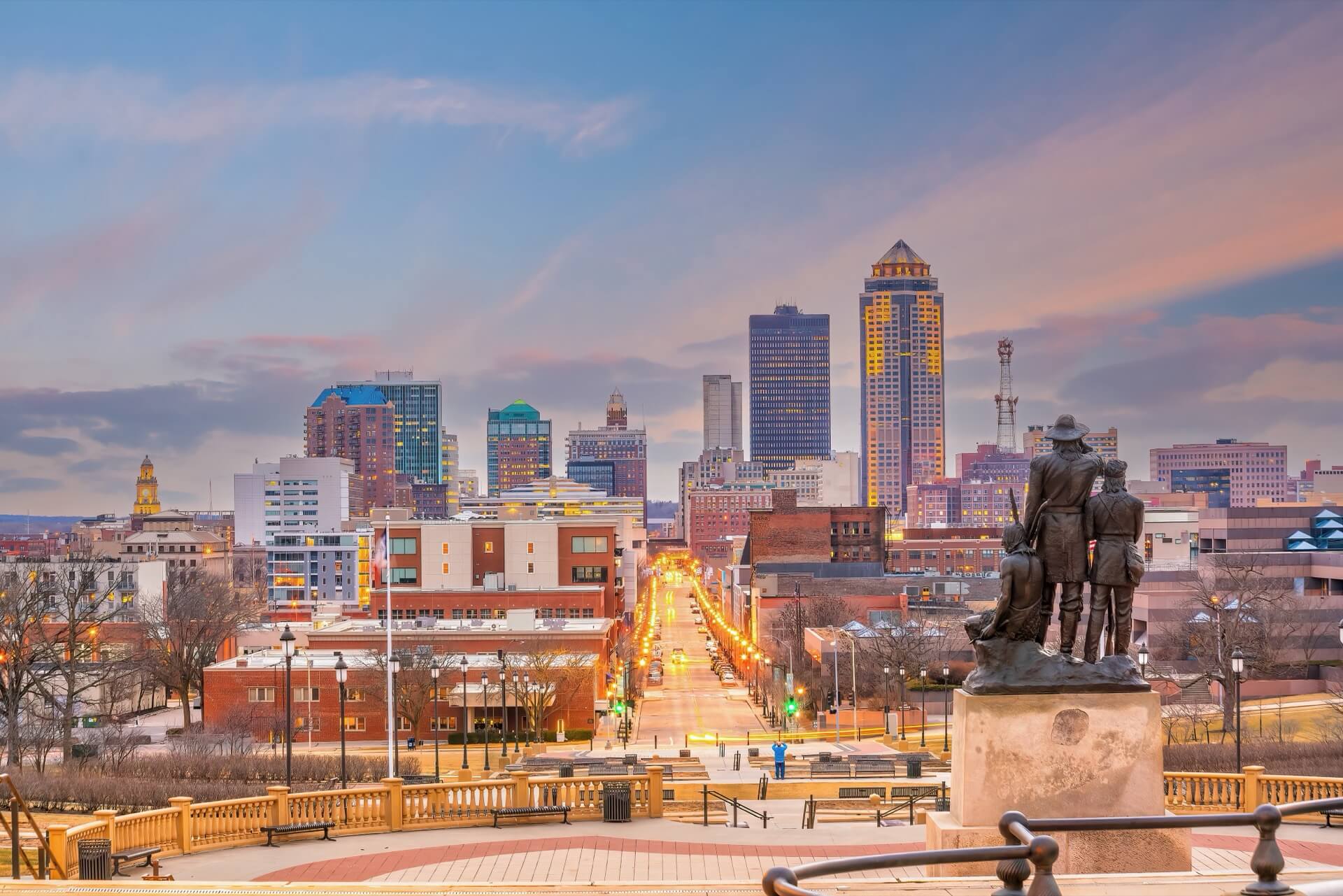 Downtown Des Moines city skyline cityscape of Iowa and public park in USA at sunset