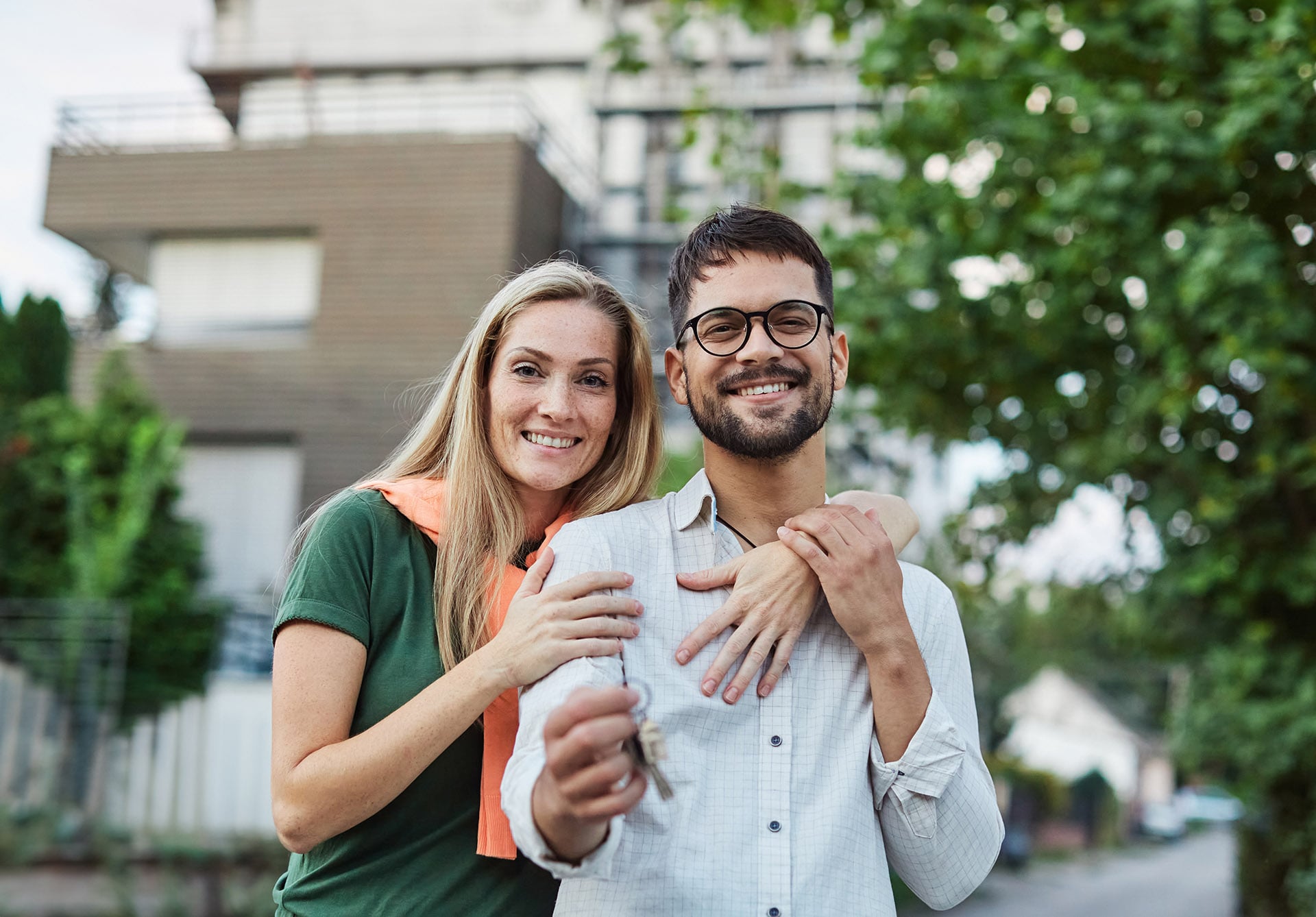 Portrait,Of,A,Happy,Young,Couple,Standing,In,Front,Of