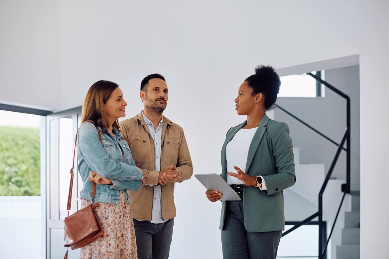 real estate agent communicating with potential couple of buyers