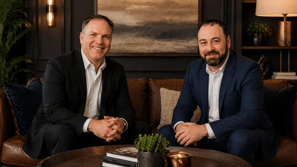 Monte Reyment and Chris Charles, a title insurance expert in Wisconsin, sitting on a luxurious couch during a podcast interview recording.