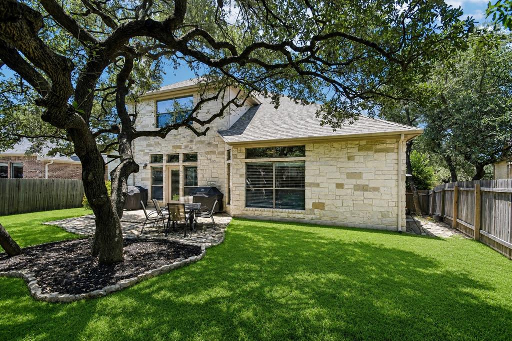 Fenced backyard with mature live oak tree at 8008 Ladera Verde Dr, Circle C Ranch Austin