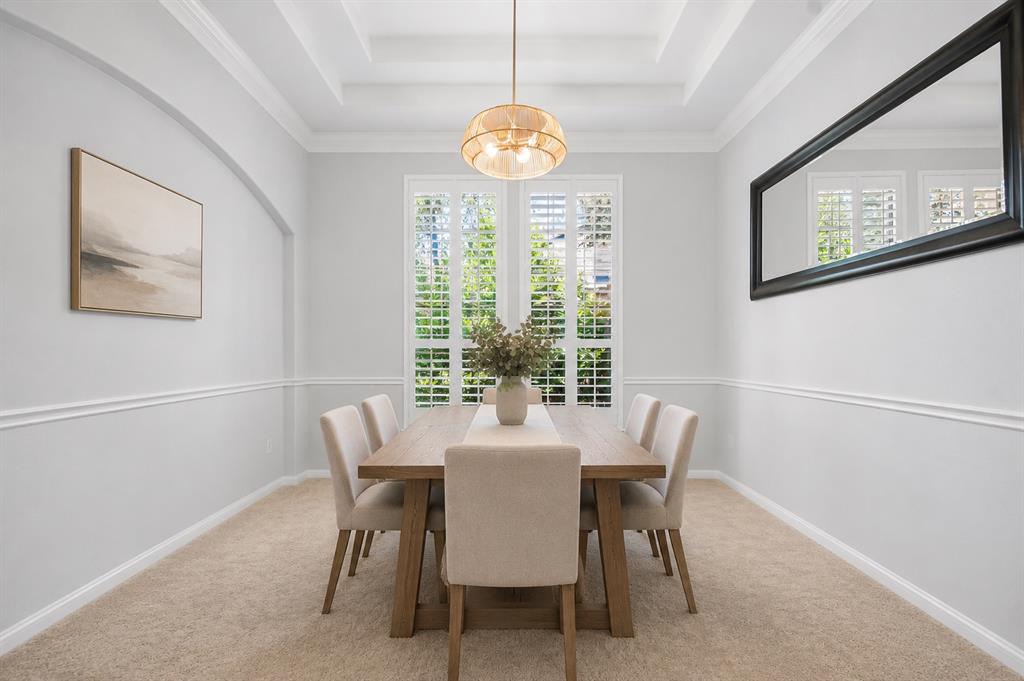 Formal dining room with tray ceiling and plantation shutters at 8008 Ladera Verde Dr