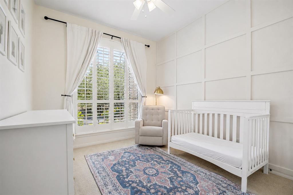 Secondary bedroom with board-and-batten accent wall at 8008 Ladera Verde Dr