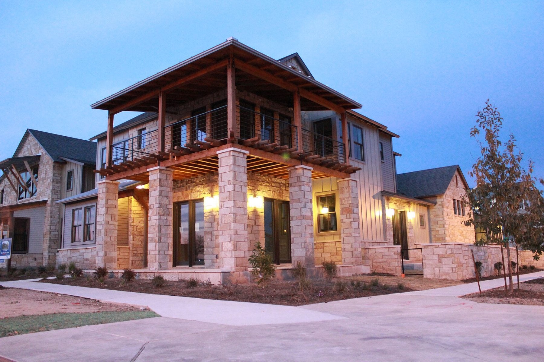 Stone and wood home in the Mueller neighborhood of Austin at dusk