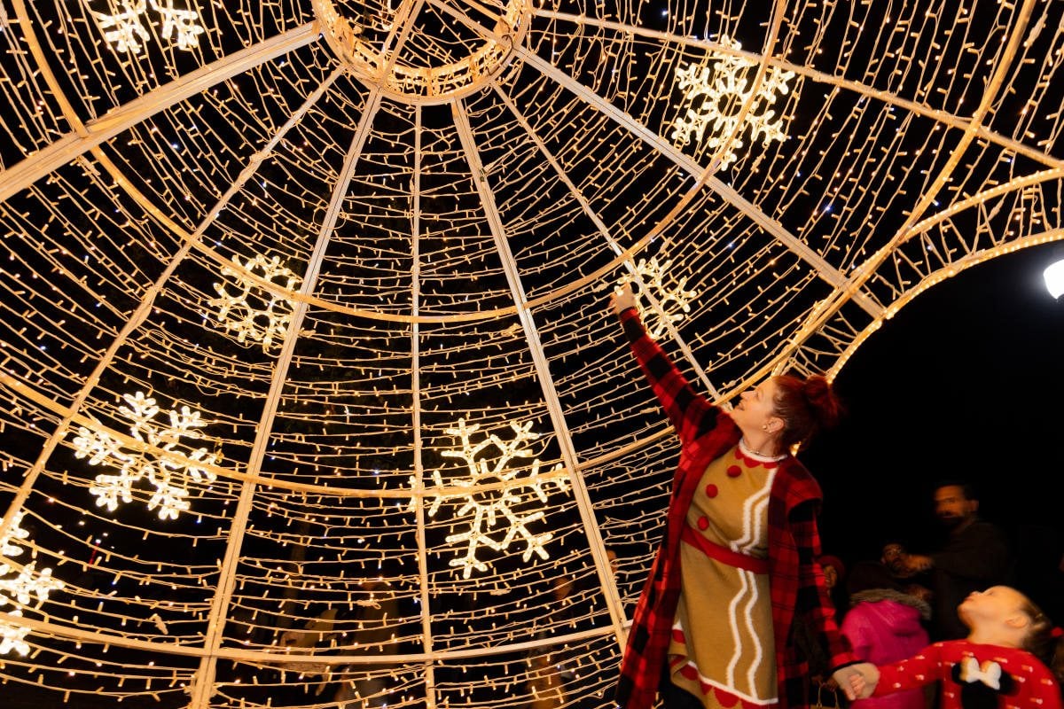 Visitor inside a lighted dome at Bastrop River of Lights