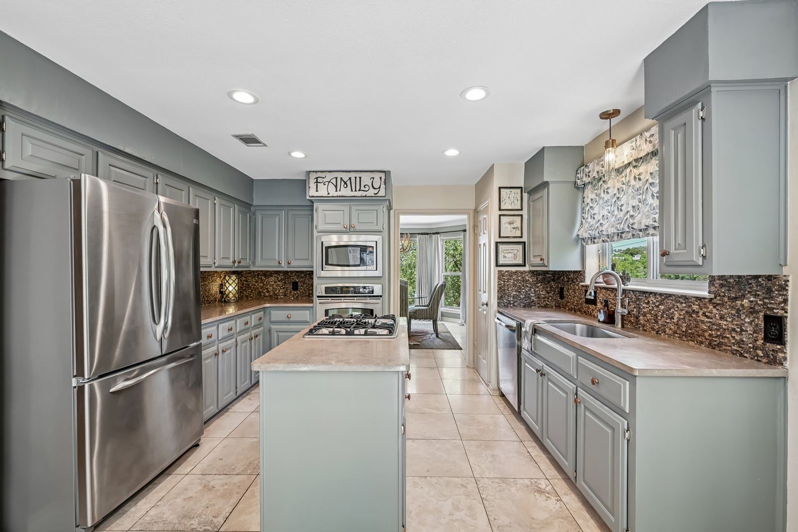 Kitchen with island gas cooktop, double wall ovens and stainless appliances at 6009 Diamond Head Dr, Austin 78746