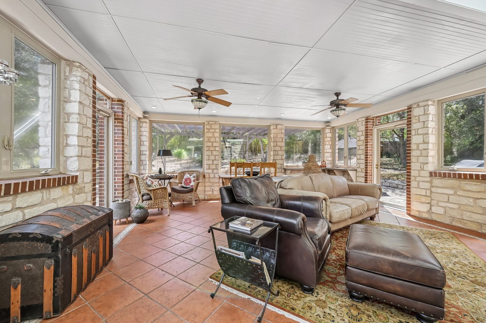 Large sunroom with Austin stone walls, skylights and backyard views at 6009 Diamond Head Dr, Lost Creek Austin
