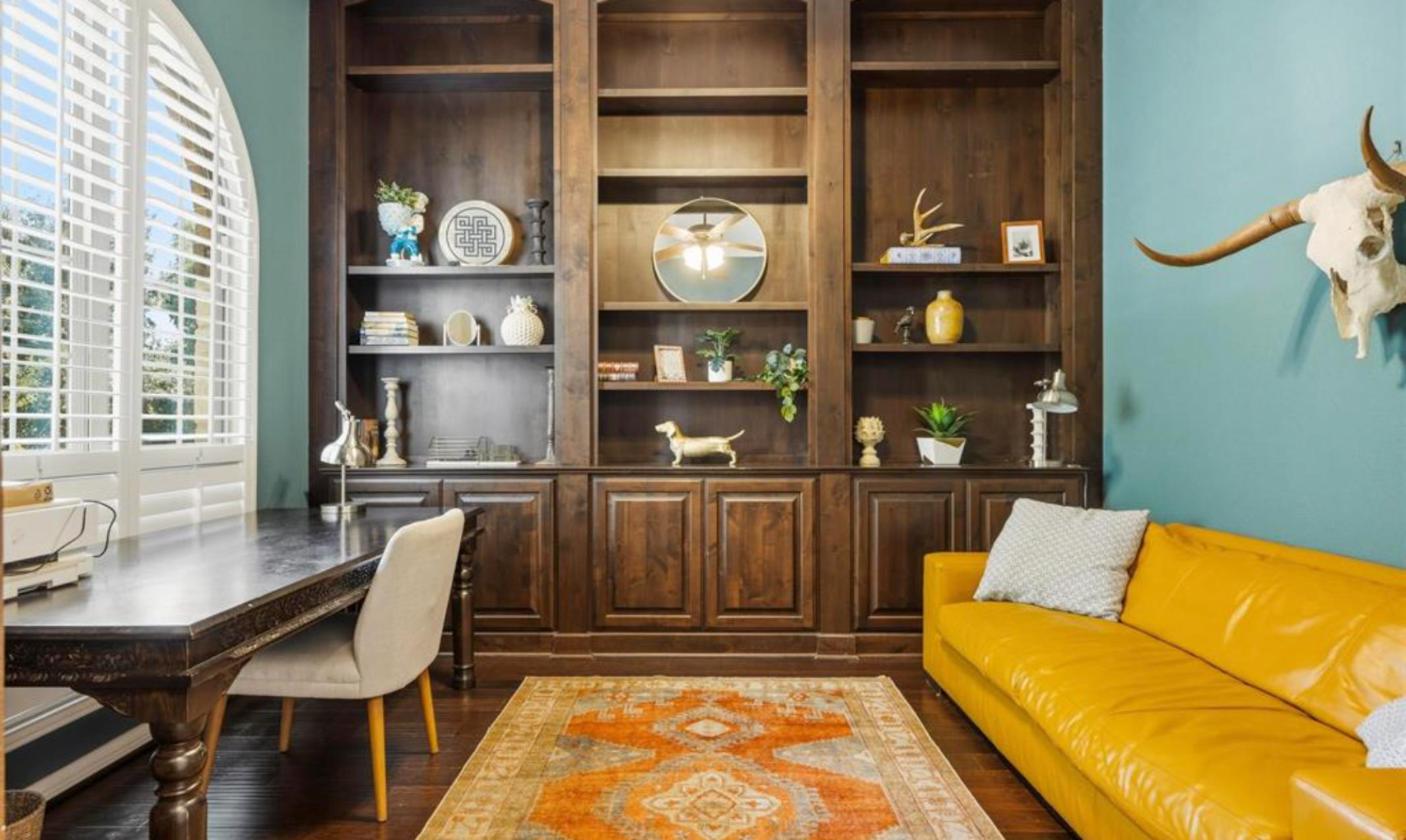 Home office with built-in dark wood cabinetry at 17312 Wildrye Dr, furnished lease in Lake Travis ISD