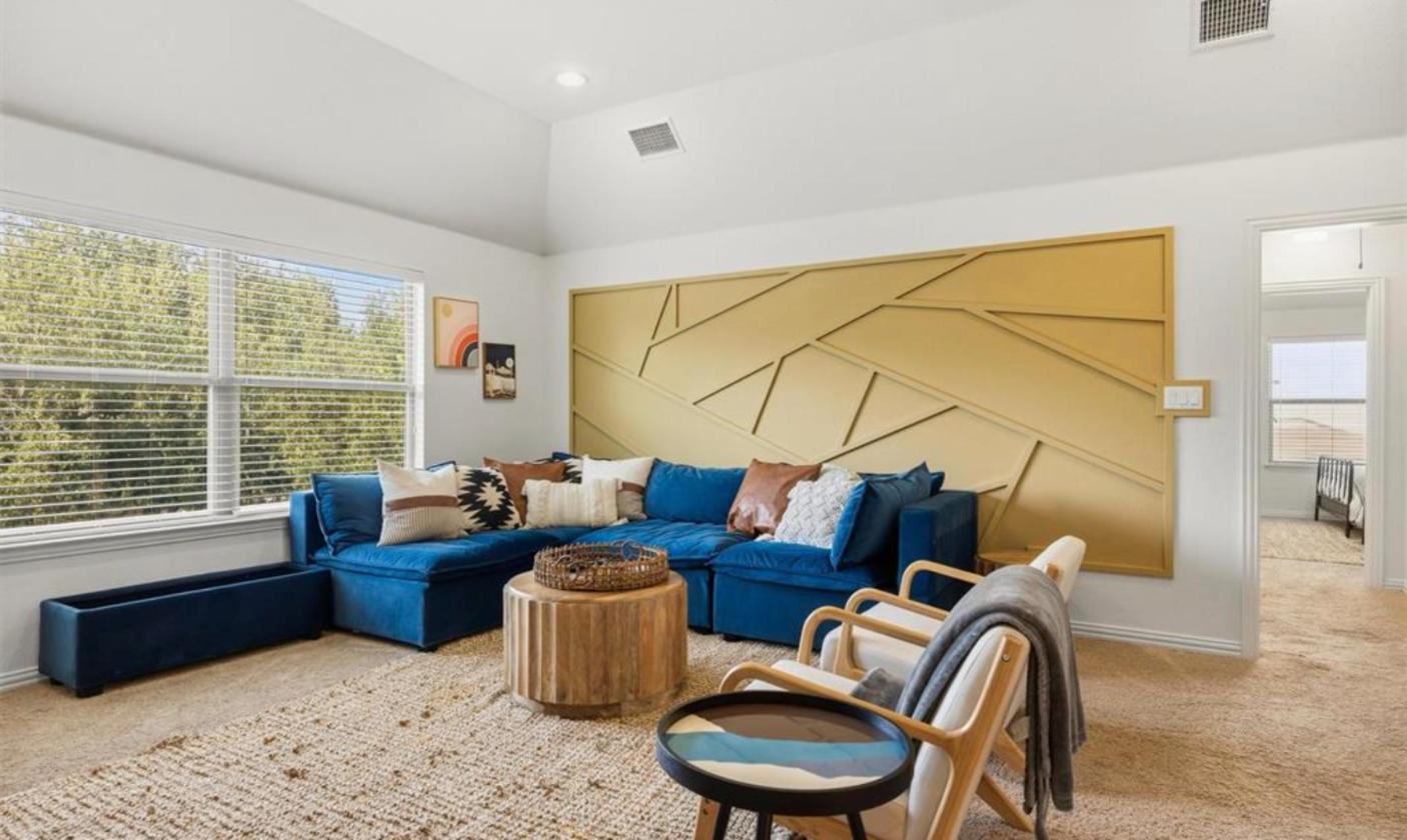 Upstairs game room with custom accent wall at 17312 Wildrye Dr, Austin TX 78738