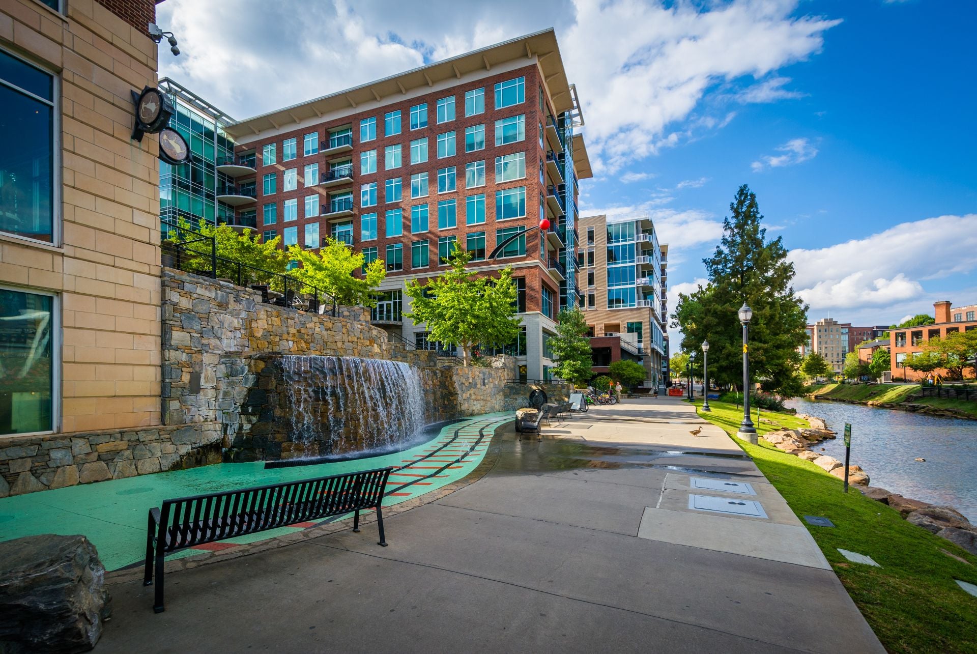 Modern buildings and walkway along the Reedy River, in downtown Greenville, South Carolina.