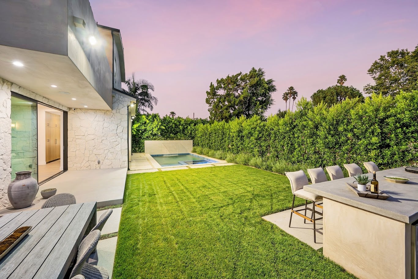 A garden with lush green grass and a pool in the backdrop. California, USA
