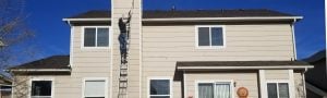 Person applying exterior paint