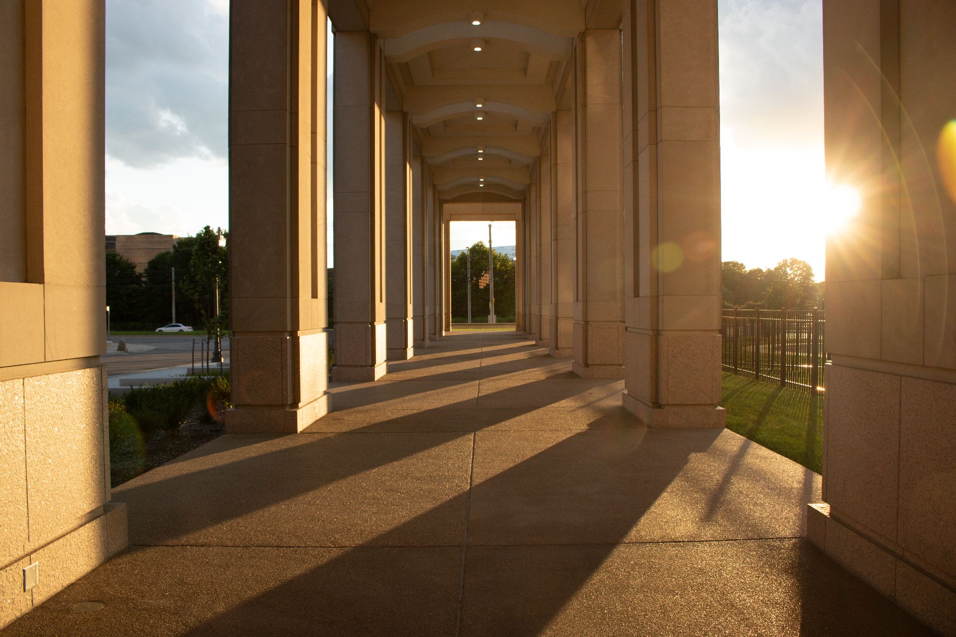 Downtown Indianapolis IN, sunset near the canal and the state building with sun light rays columns through columns.