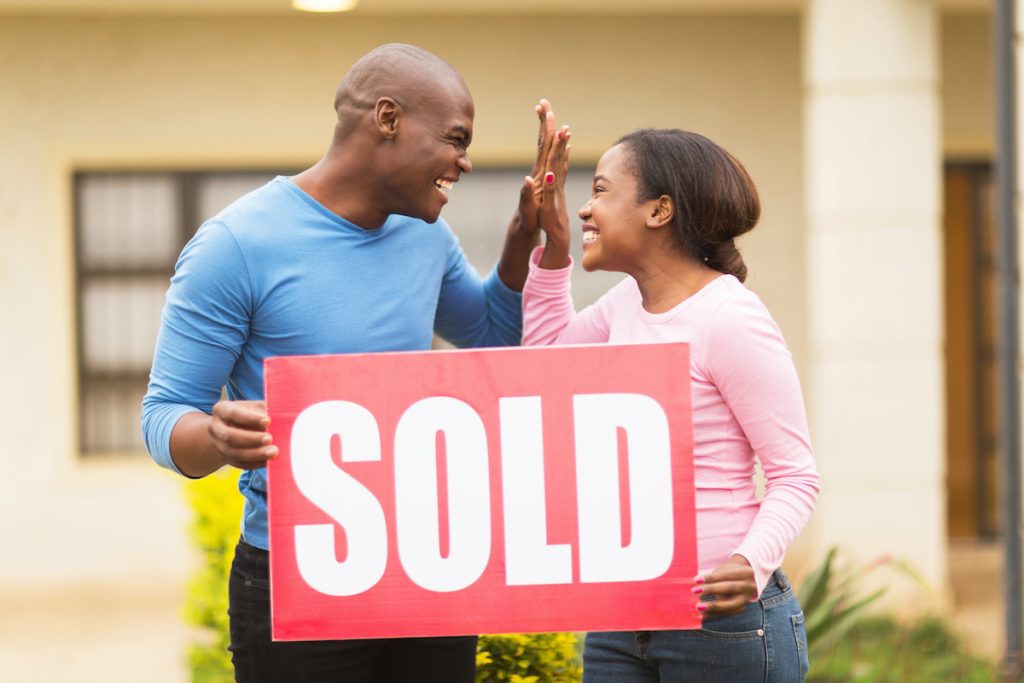 sold-home-sign-couple-sellers-1024x683