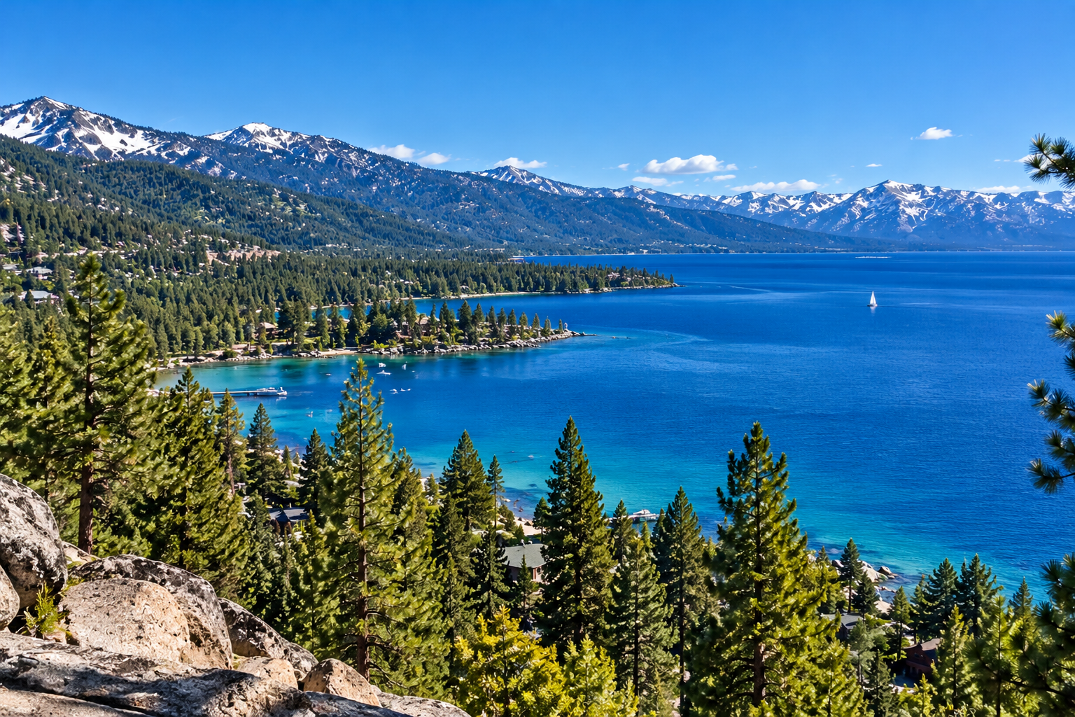 North Lake Tahoe featuring turquoise water, pine-covered shoreline, granite boulders, and Sierra Nevada mountains. Copy