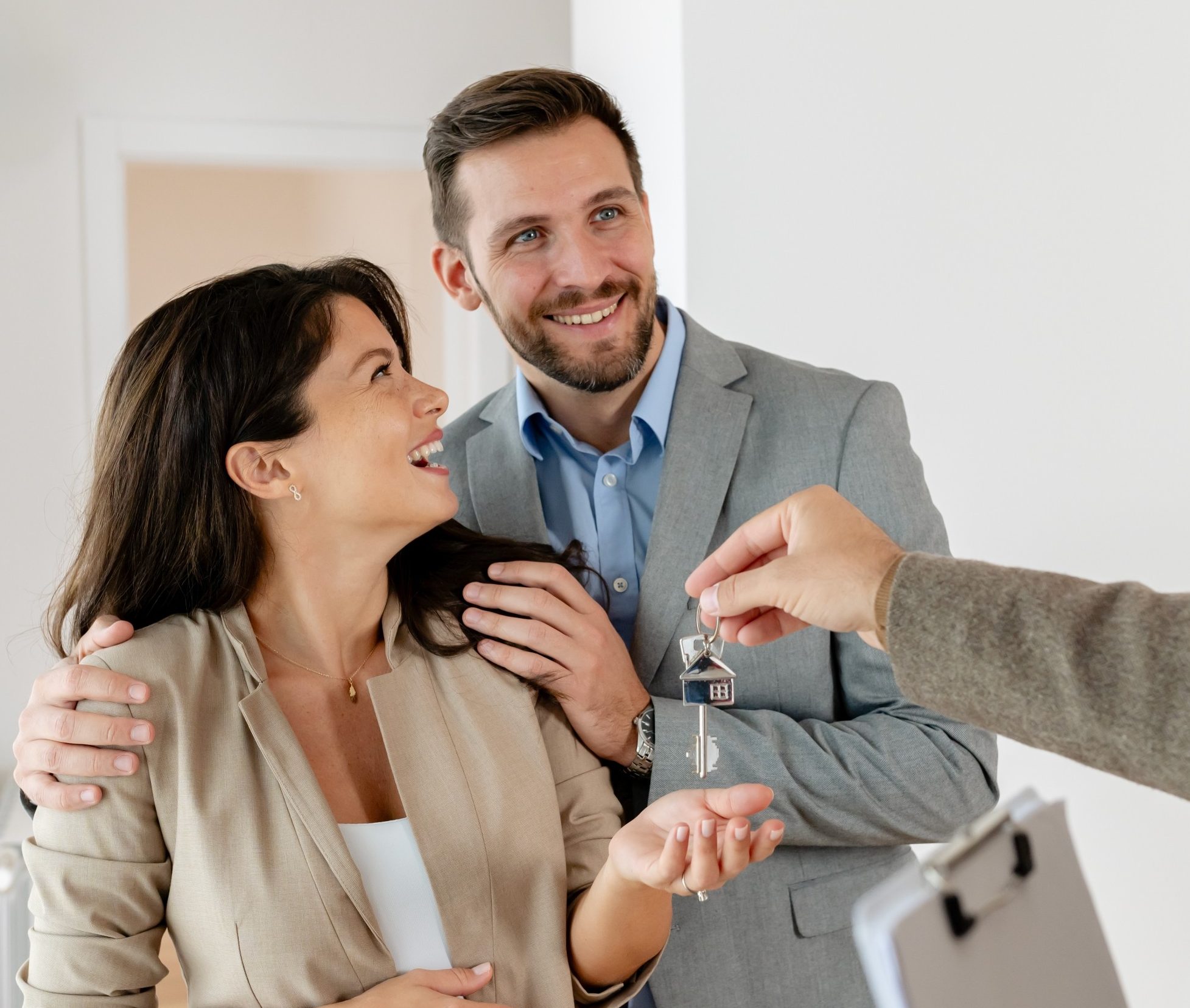 A young, beautiful, and cheerful couple, a man and his pregnant wife, talking with a real-estate