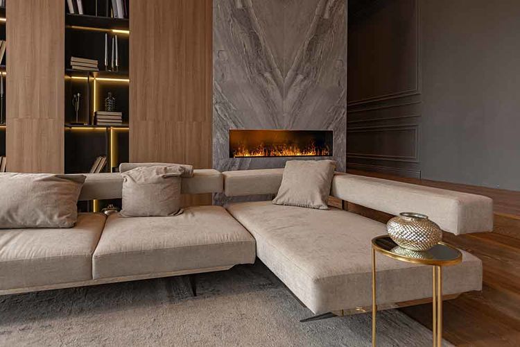 Jones-Pappas-living-room,-marble-wall-fireplace-and-stylish-bookcase