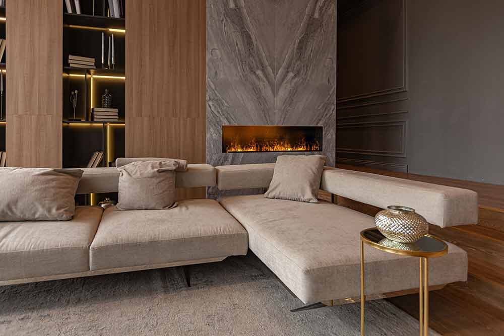 Jones-Pappas-living-room,-marble-wall-fireplace-and-stylish-bookcase