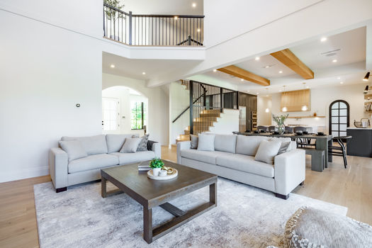 Elegant and spacious open concept interior rooms new construction with concrete floors designer decor wood beams on ceiling classic style