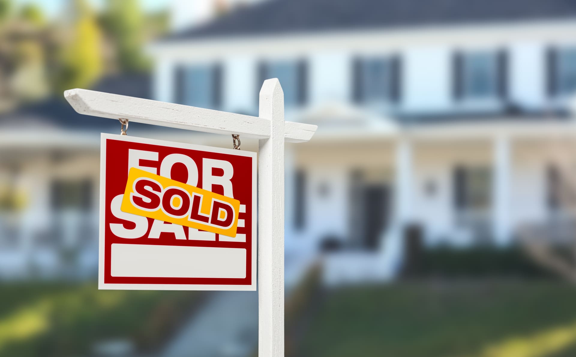 Sold Home For Sale Real Estate Sign in Front of Beautiful New House