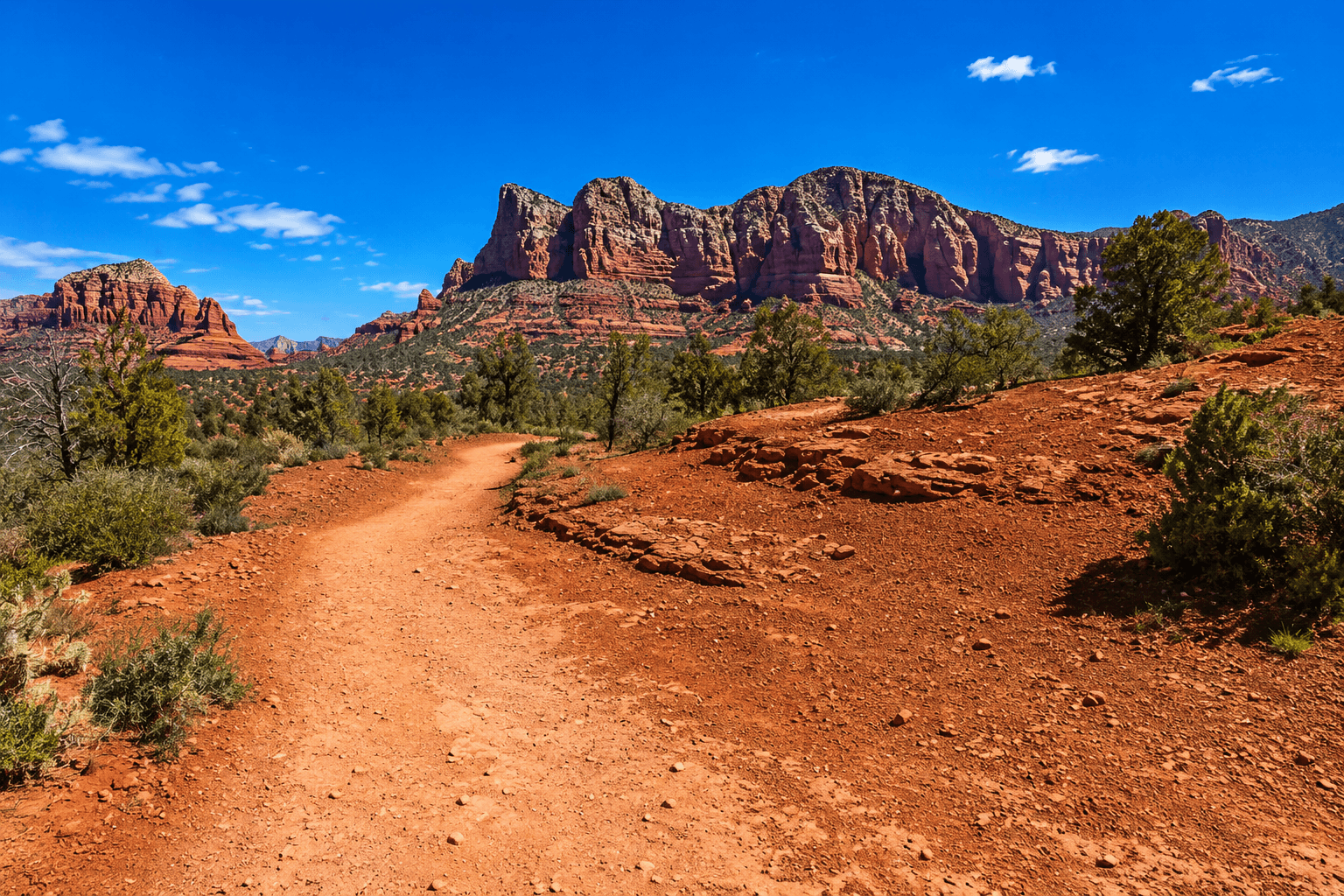 Desert trail towards red mesas
