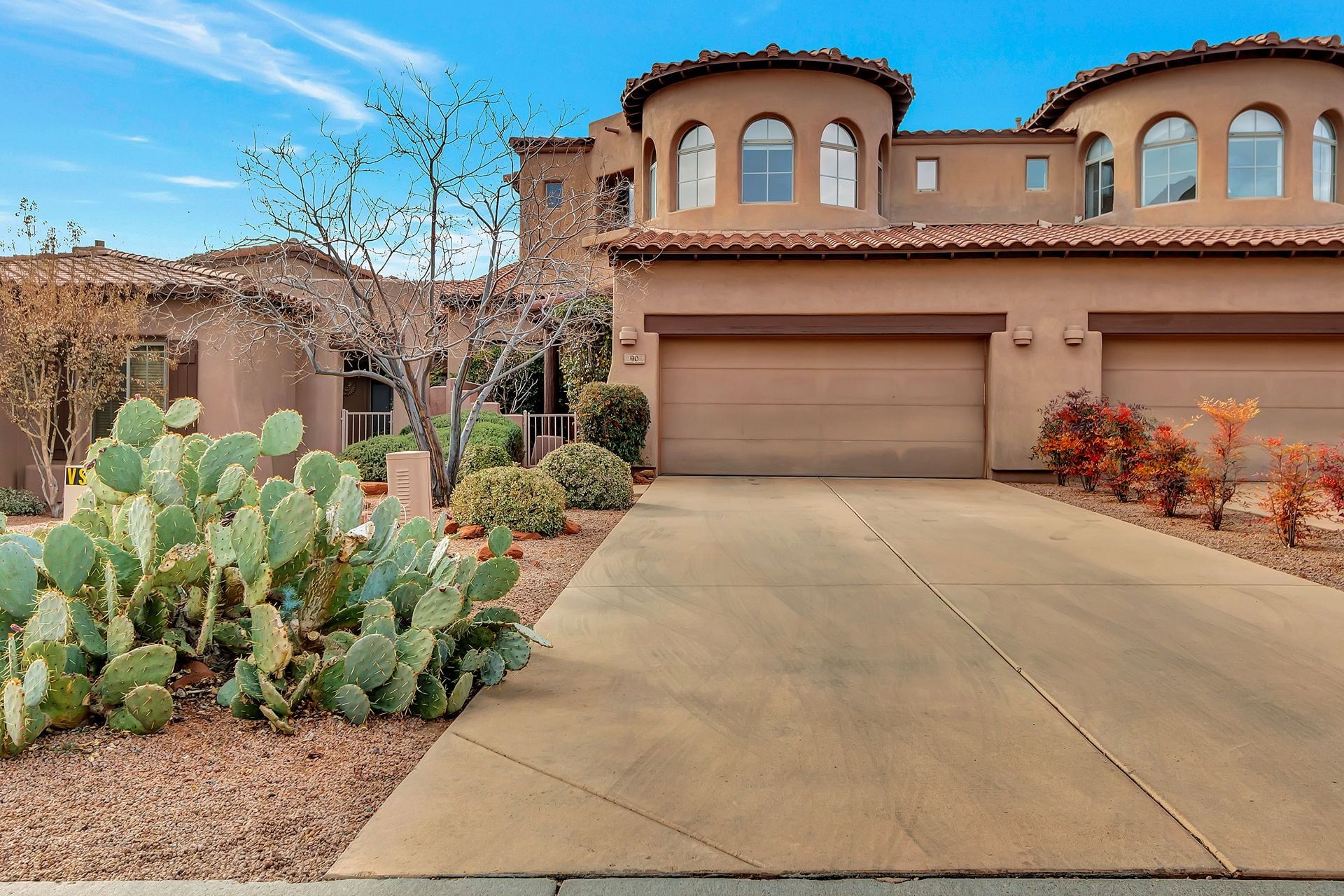 Southwestern Sedona home with stucco exterior, desert landscaping, cactus garden, and mountain surroundings