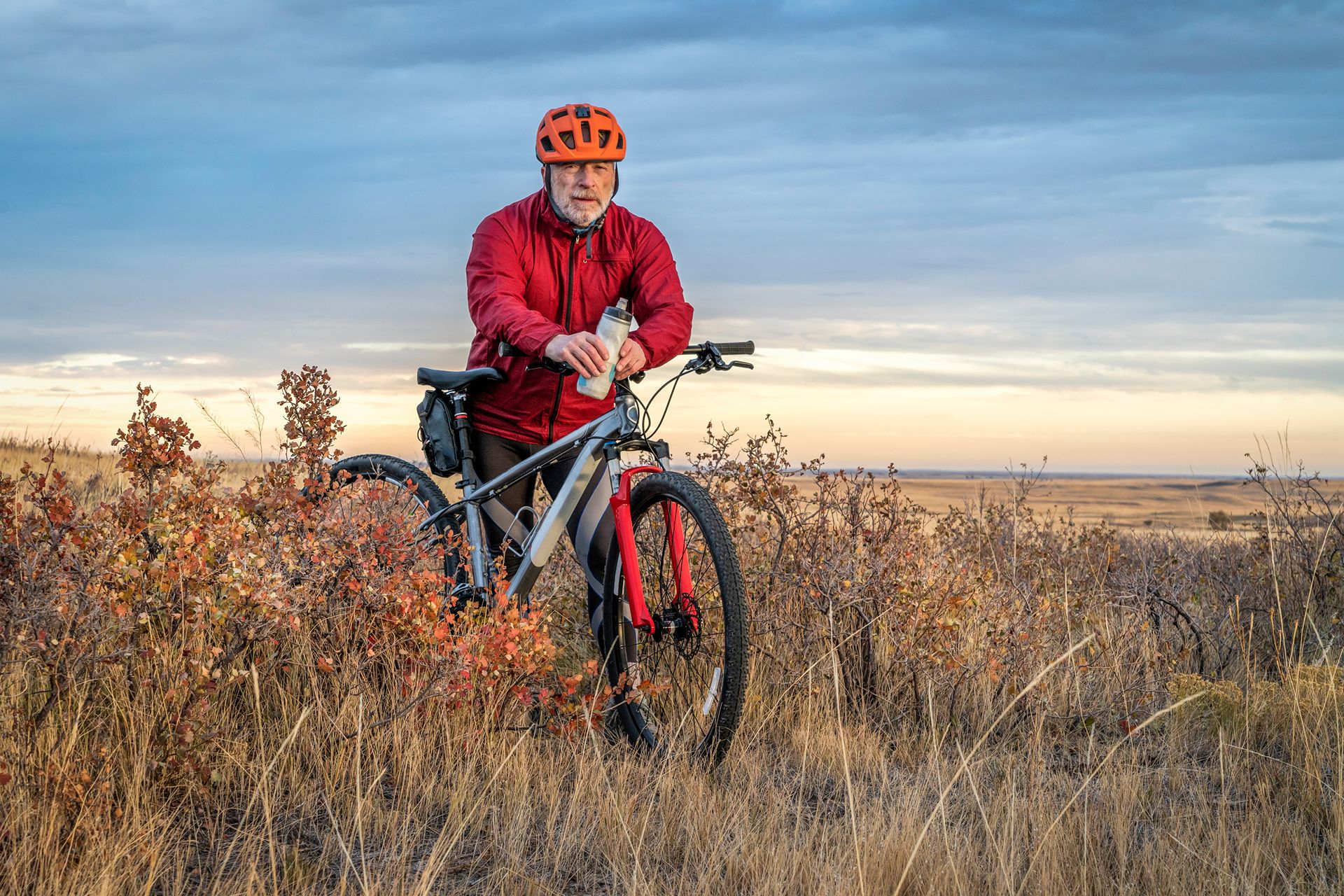 senior cyclist is riding mountain bike in Colorado prairie - Soapstone Prairie Natural Area with last fall colors in late October