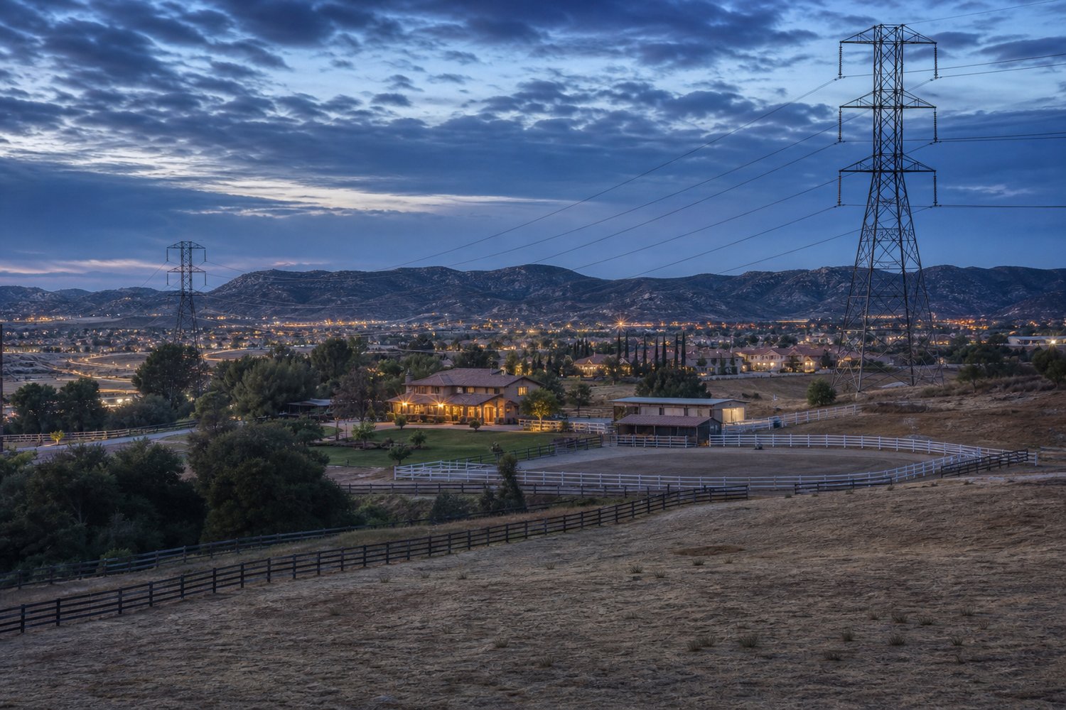 Rural road and utility lines crossing open acreage land in Temecula, California
