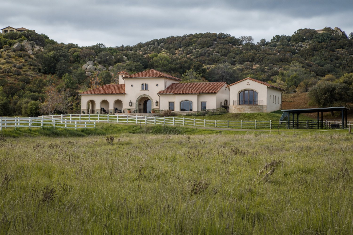 Mediterranean-style custom estate with a tile roof on open grassy acreage in La Cresta, Murrieta, California