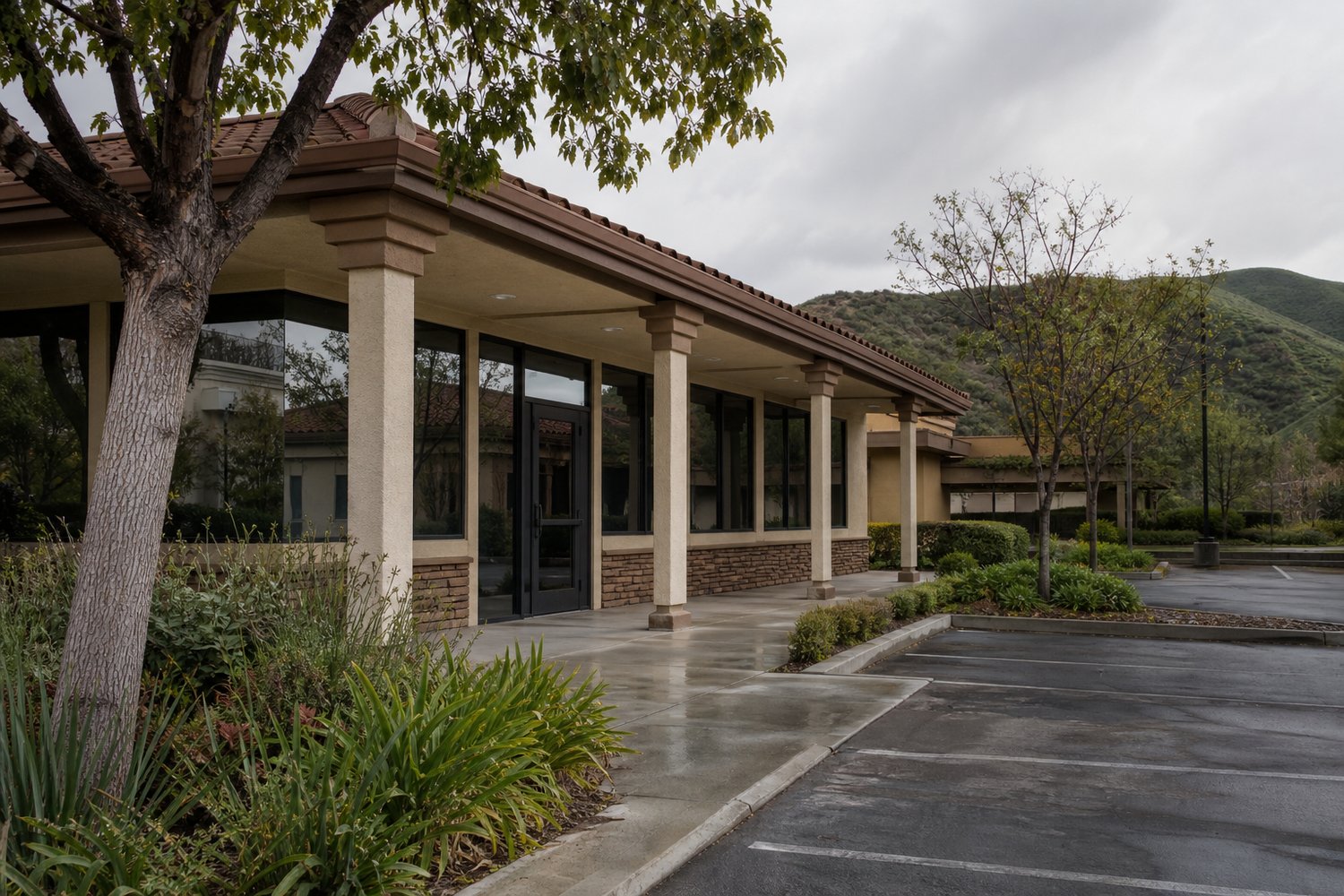 Single-story office building with a covered walkway and landscaped grounds near hills in Temecula, California