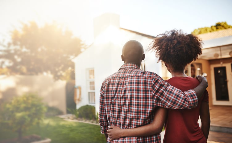 Back view, black couple and hug outdoor at house, real estate and new loan for luxury home. Man, woman and people in front of property investment, moving and dream neighborhood for building mortgage