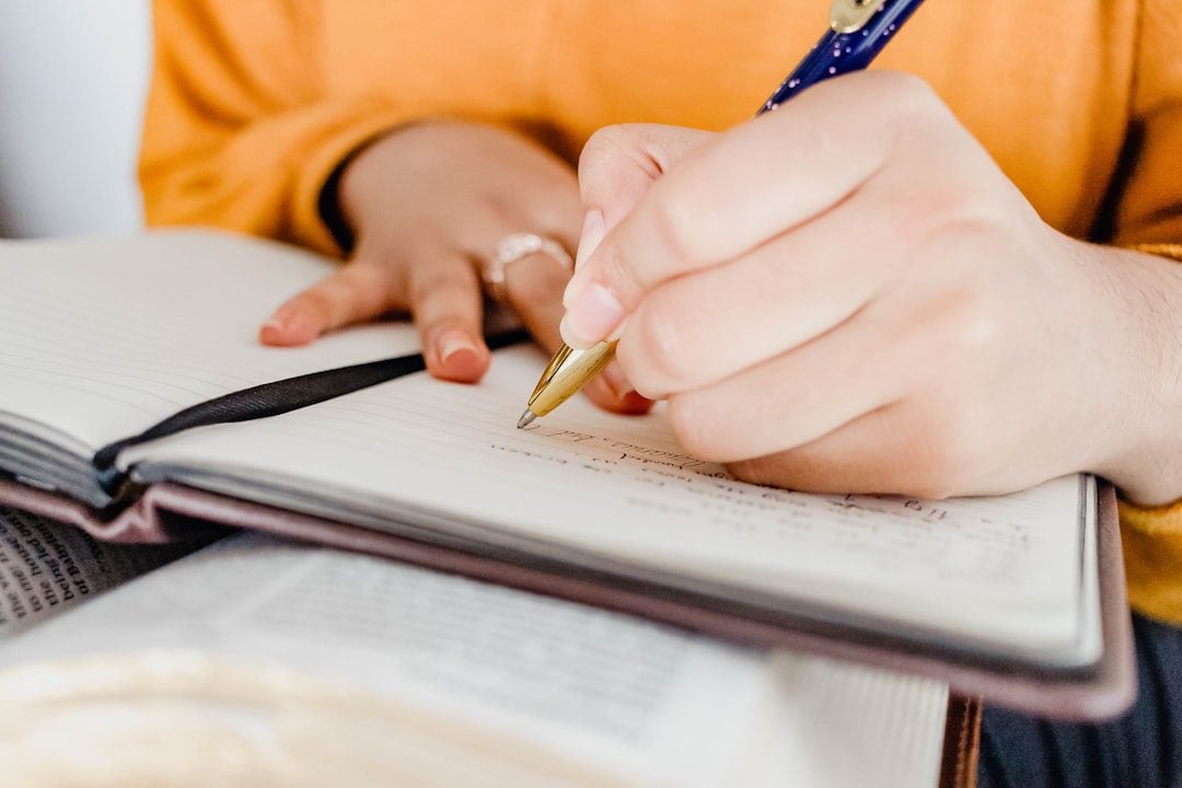 Hand holding a pen checking off tasks on a detailed checklist, symbolizing a comprehensive process.