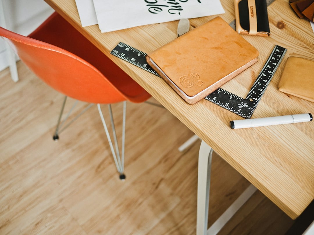 Close-up view of detailed architectural blueprints spread across a clean, modern desk, symbolizing the strategic and preci...