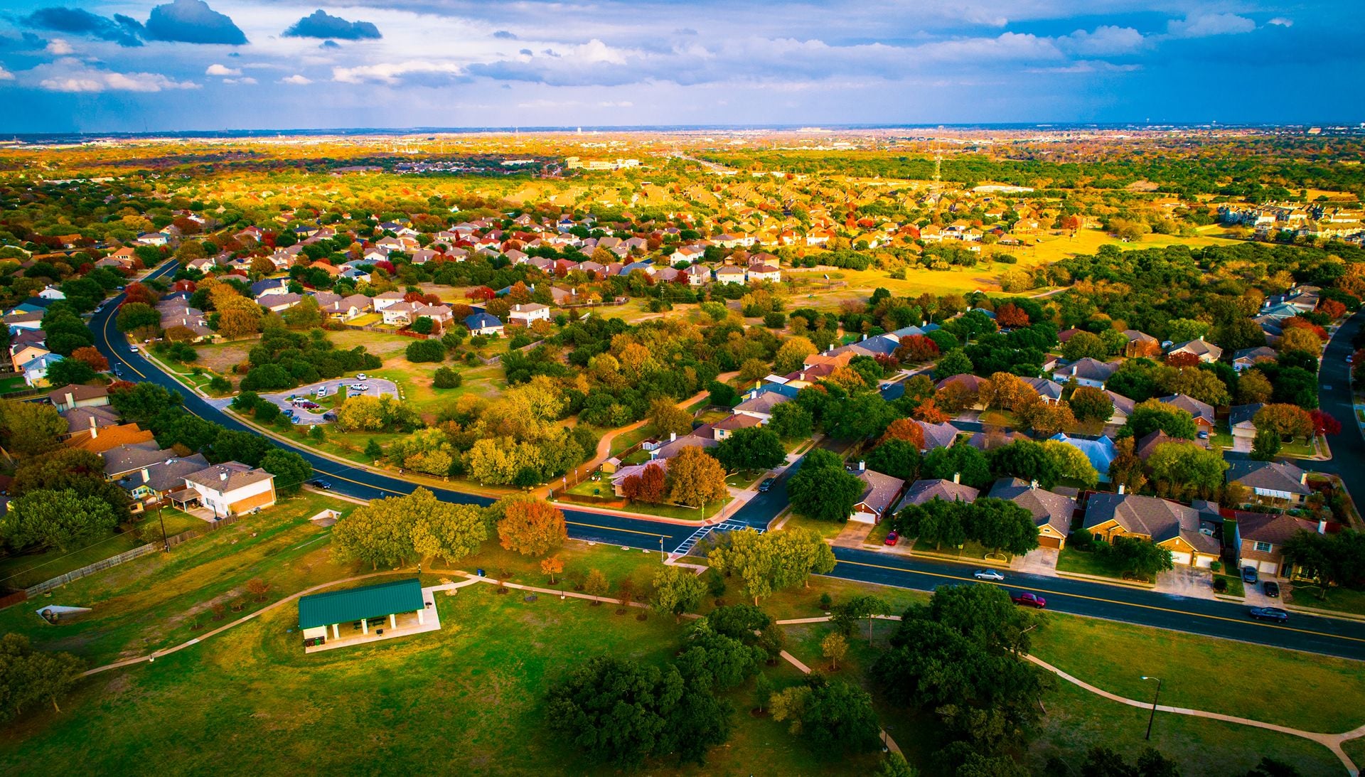 open Texas land for sale expanding housing development fall Autumn suburb suburbia round Rock Texas colorful landscape trees changing colors fall in central texas